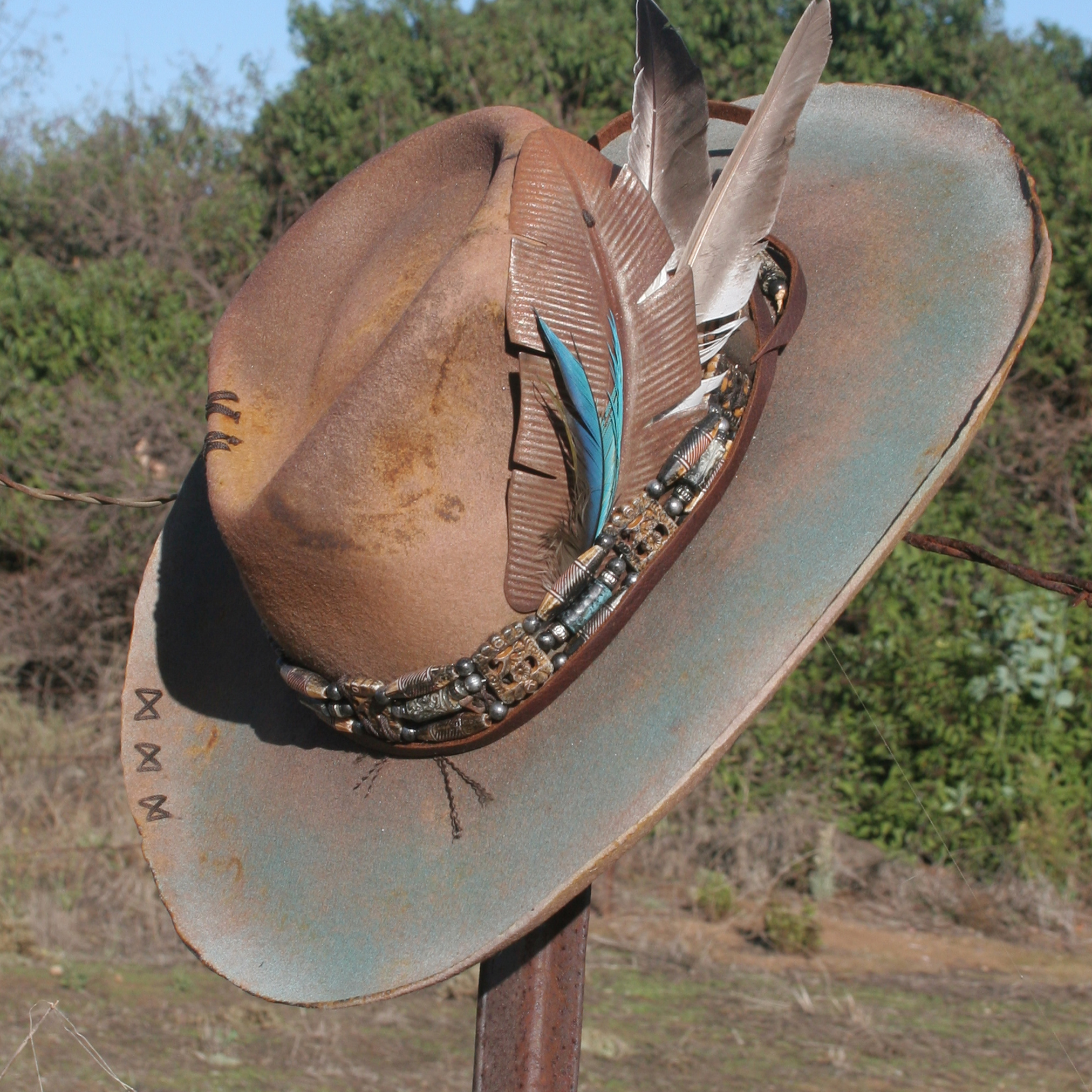 Hat with turquoise and metal feathers, stitching and beaded head band